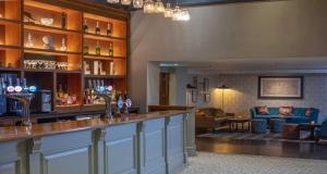 a lobby with a bar and a living room at Best Western Plus Angel Hotel in Chippenham