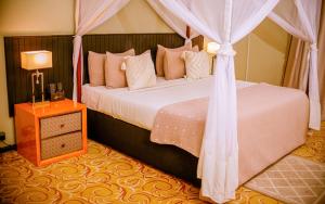 a bedroom with a bed with a canopy at Heritage by Serendib in Blantyre