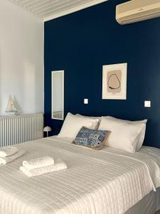 a blue bedroom with a large bed with two pillows at Sea You Soon & Spa 1 in Methana +67 photos
