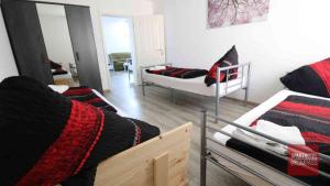 a living room with two beds and a mirror at Aparthotel Kompass A 201 in Essen