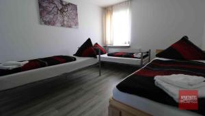 a room with two beds and a window at Aparthotel Kompass A 201 in Essen