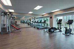a gym with a row of treadmills and machines at AC Hotel by Marriott San Jose Escazu in San José