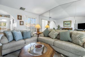 a living room with a couch and a table at Stylish Condo with Private Pool & & Panoramic View in Palm Springs