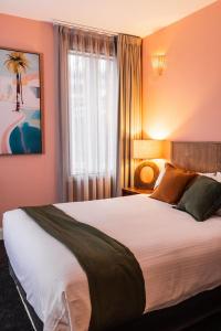 a bedroom with a large bed and a window at The Lucky Hotel in Newcastle