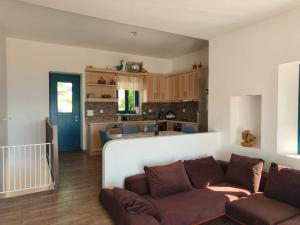 a living room with a couch and a kitchen at Kedros in Leipsoi