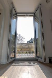 an empty room with large sliding glass doors at Green Terrace in Cernobbio center in Cernobbio