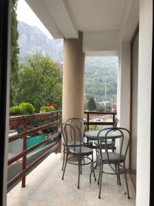 a patio with chairs and a table on a balcony at Pinul Negru in Băile Herculane