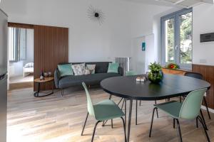 a living room with a table and chairs and a couch at Green Terrace in Cernobbio center in Cernobbio +16 photos