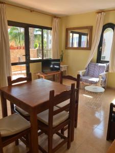 a living room with a wooden table and chairs at Confortable Apartment in Corralejo in Corralejo