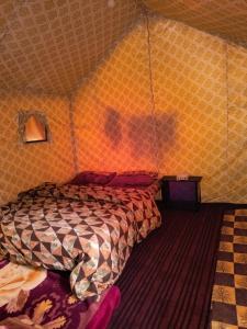 una persona in una stanza con un letto in una tenda di Shanti People Huts And Cafe a Kasol