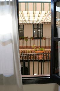 a view from a window of a balcony with a table at AvantiStays Capote in Seville