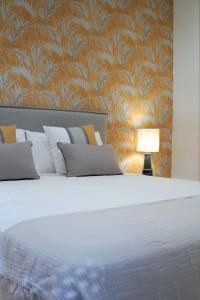 a bedroom with a large white bed with a lamp at AvantiStays Capote in Seville