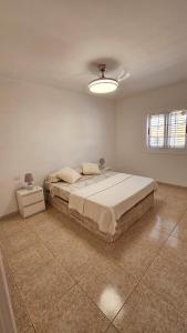 a bedroom with a large bed and a night stand at Atlantic Blue Dream Caletillas in Araya +14 photos