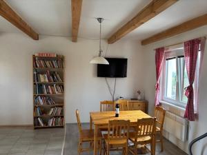 a dining room with a wooden table and chairs at Apártmány Sedlec in Sedlec