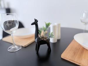a figurine of a giraffe on a table with a wine glass at PostBox Apartments in Birmingham City Centre Near Birmingham Canal in Birmingham +10 photos