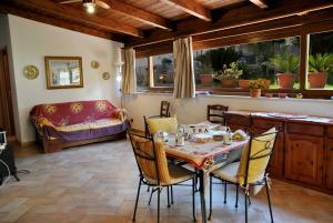 a dining room with a table and chairs at La casina di Marta in Formia