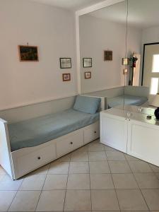 a room with a bed and a sink and a mirror at Rondinella in San Vito Chietino