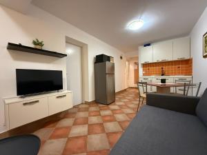 a living room with a television and a kitchen at apartmani selce in Selce