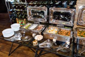 a buffet with many trays of food on a table at Boutique Spa Casino Hotel Lybid Plaza in Khmelnytskyi