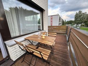 a wooden table and chairs on a balcony at 150qm-6 Rooms-Free Privat Parking-2 Bathrooms-Wifi-Yihapartment in Hannover