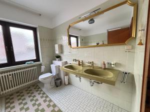 a bathroom with a sink and a toilet and a mirror at 150qm-6 Rooms-Free Privat Parking-2 Bathrooms-Wifi-Yihapartment in Hannover +16 photos