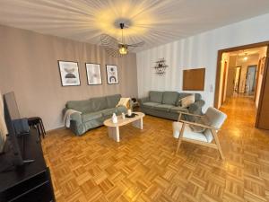 a living room with a couch and a table at 150qm-6 Rooms-Free Privat Parking-2 Bathrooms-Wifi-Yihapartment in Hannover