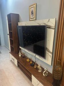a large flat screen tv sitting on a entertainment center at 1 Bed Room Apartment near Tariq road in Karachi