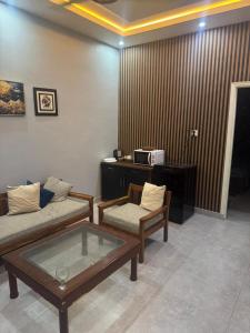 a living room with a couch and a table at 1 Bed Room Apartment near Tariq road in Karachi