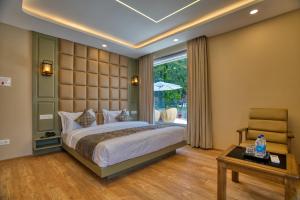 a bedroom with a large bed and a table at Mountain Nest A Boutique Stay Near Dal Lake, Srinagar in Srinagar