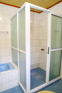 a shower with glass doors in a bathroom at Guyana Guest House in Naivasha +30 photos