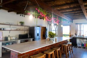 a kitchen with a bar with stools and a counter top at 7 Oaks in Kenton on Sea