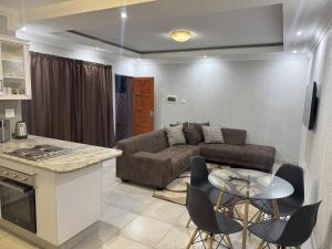 a living room with a couch and a table at Mikan AirBnB in Otjiwarongo