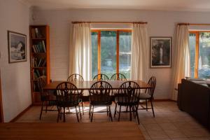 a dining room with a table and chairs at Yellowwood Place in Bettyʼs Bay