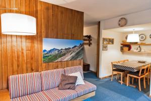 a living room with a couch and a table at Chesa San Gian ground floor - Celerina in Celerina