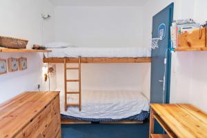 a room with bunk beds and a ladder at Chesa San Gian ground floor - Celerina in Celerina