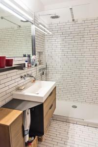 a bathroom with a sink and a white brick wall at Chesa San Gian ground floor - Celerina in Celerina +21 photos