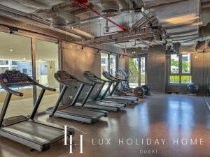 a row of exercise bikes in a gym at LUX - The La Mer Sea View Suite 3 in Dubai