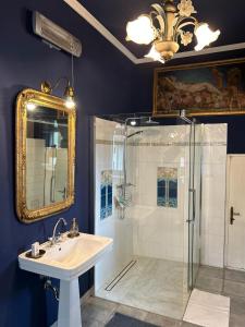 a bathroom with a shower and a sink and a mirror at Weinvilla in Wolkersdorf