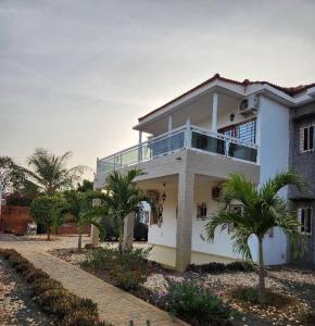 a white house with palm trees in front of it at Sen Keur in Somone +36 photos
