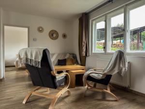 a living room with two chairs and a table at Apartmán Lnáře in Lnáře +24 photos