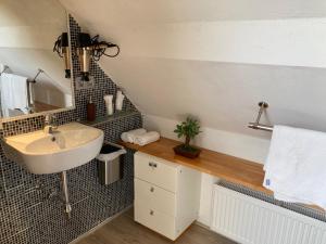 a bathroom with a sink and a counter with a mirror at Caravaggio Boutique Suites in Antwerp +33 photos