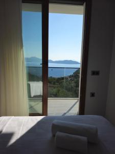 a bedroom with a bed and a large window at Asiyan Villas in Marmaris