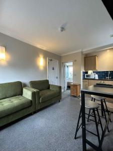 a living room with a couch and a table at Orla Restaurant & Rooms in Lindfield +3 photos