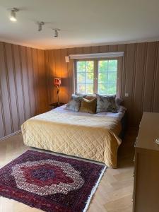 a bedroom with a bed with a window and a rug at Family-Friendly Villa in Oslo - Holmenkollen in Oslo