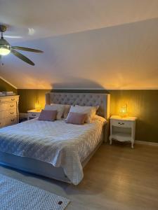 a bedroom with a large bed with two night stands at Family-Friendly Villa in Oslo - Holmenkollen in Oslo +42 photos