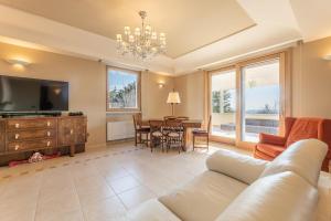 a living room with a couch and a tv and a table at Villa Gentileschi in Casarano