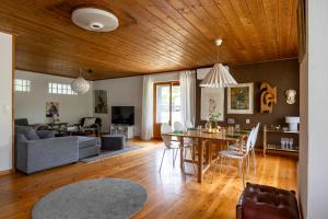 a living room with a table and a dining room at Scenic Lakehouse near Stockholm with Sauna & Jetty in Huddinge