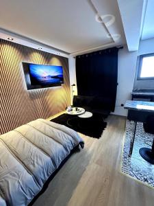 a bedroom with a bed and a table and a piano at Studio au Cœur de Rabat in Rabat +12 photos
