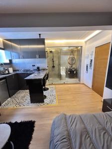 a kitchen and a living room with a sink and a bathroom at Studio au Cœur de Rabat in Rabat