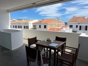 a table and chairs on a balcony with a view at Riera Rossello 3 in Fornells